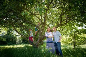 Newborn baby and family in the climbing tree